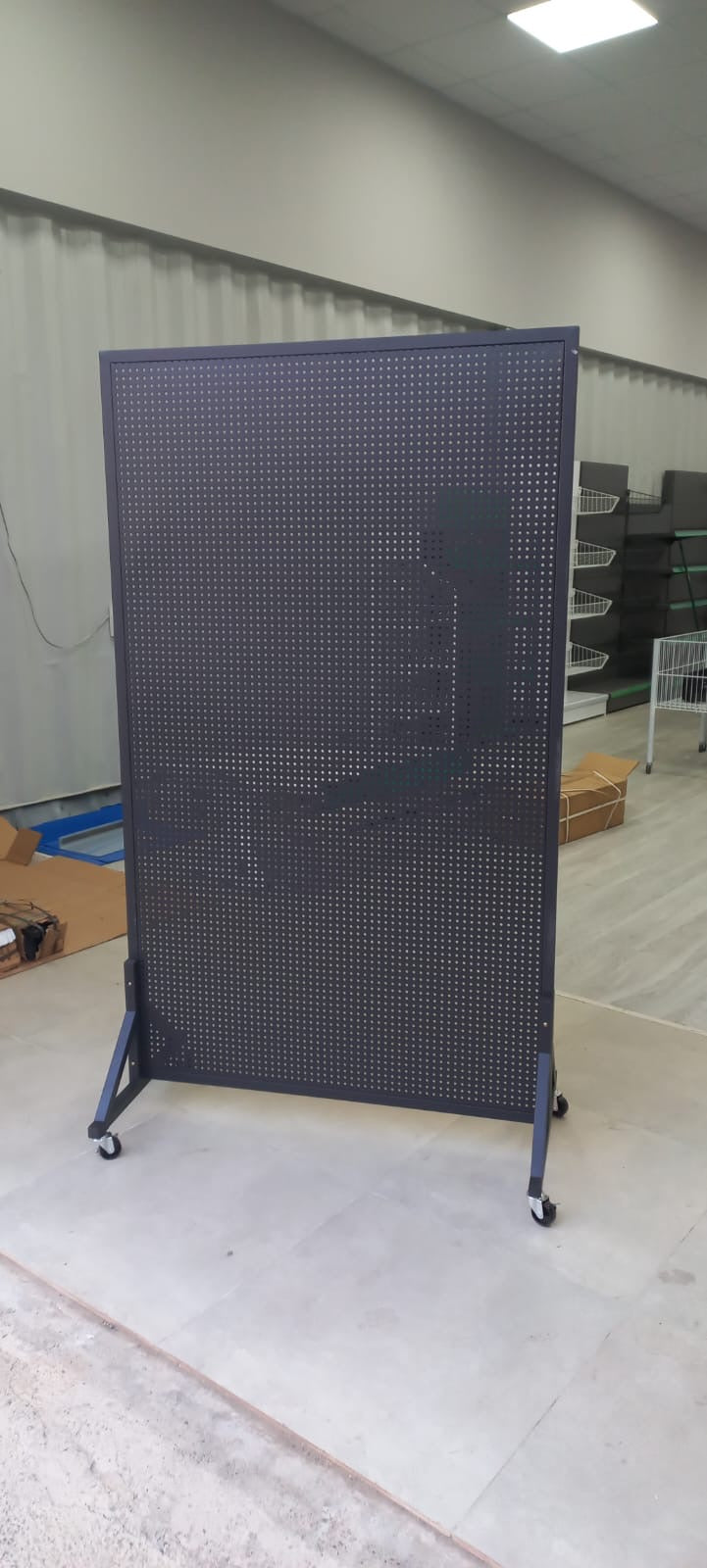 Perforated wall for hanging products with wheels