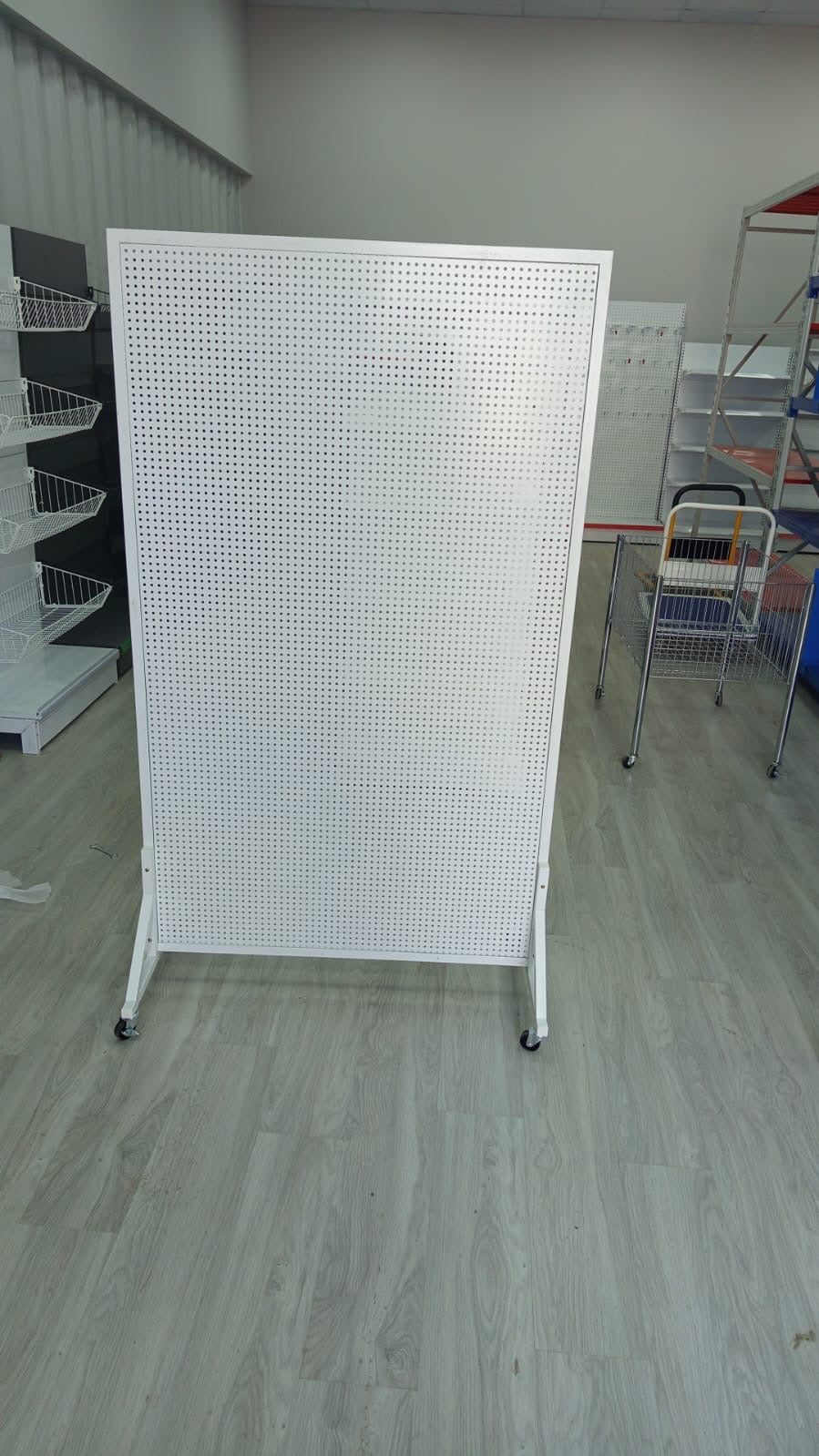 Perforated wall for hanging products with wheels